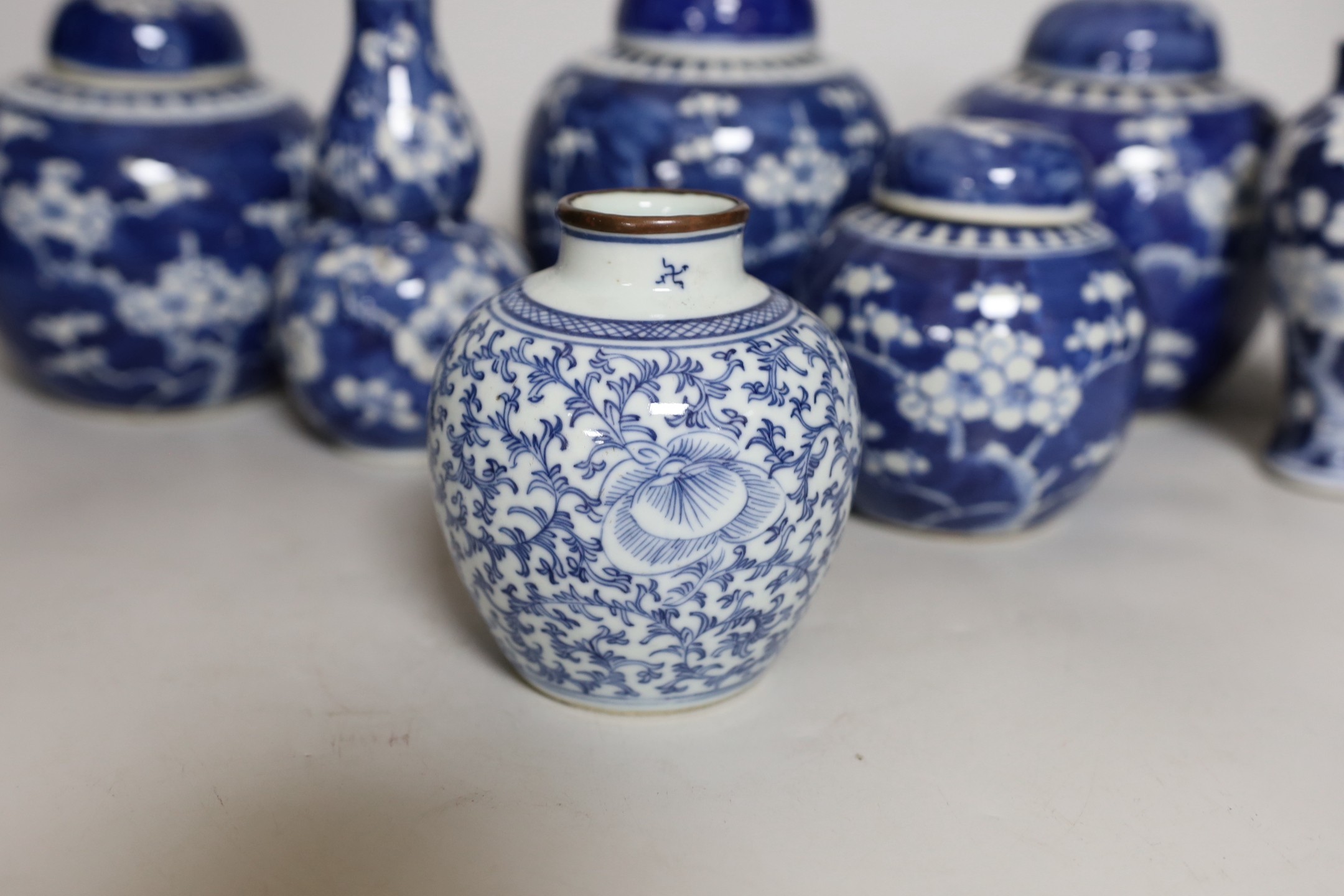 Four Chinese blue and white prunus pattern ginger jars, together with three similar vases. 19th/early 20th century, Tallest 15cm